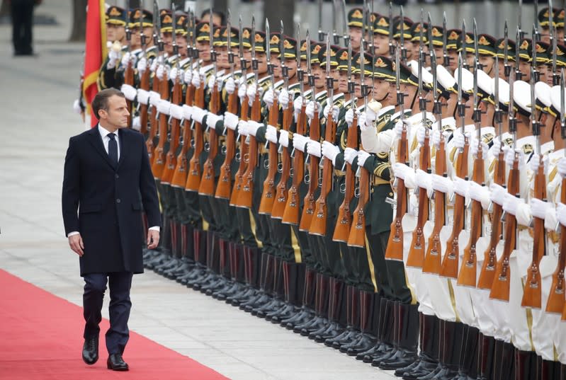 French President Emmanuel Macron attends a welcoming ceremony hosted by China's President Xi Jinping in Beijing