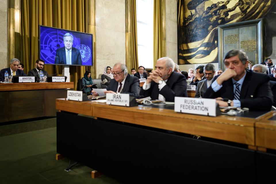 UN Secretary-General Antonio Guterres is seen on a TV screen while delivering a speech during the United Nations Conference on Afghanistan at the UN Offices in Geneva, Switzerland, Wednesday, Nov. 28, 2018. (Fabrice Coffrini/pool photo via AP)