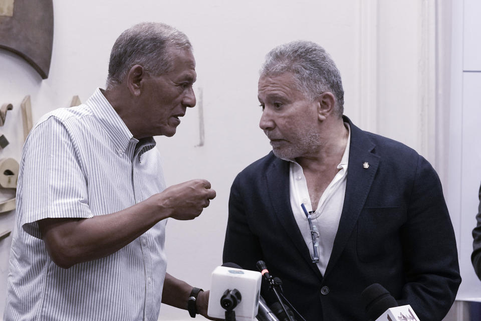 Akmal Qortam, the head of Egypt's Conservative Party, right, speaks to Mohamed Anwar Esmat Sadat, the head of The Reform and Development Party, left, during a presser held by the Free Current coalition in Cairo, Egypt, Monday, Aug. 28, 2023. A new coalition of Egyptian political parties has publicly criticized the country's current government on Monday for persecuting politicians. In a presser Monday a spokesmen for the coalition said the practices of the current government are a danger to the country's future. (AP Photo/Amr Nabil)