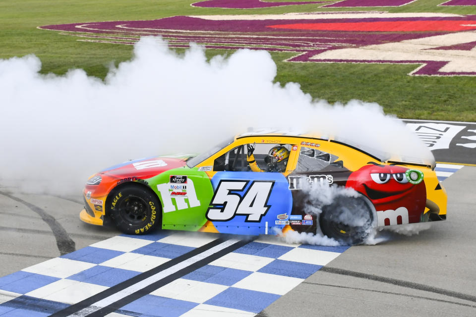 Kyle Busch does a burnout at the finish line after winning the NASCAR Xfinity Series auto race Saturday, June 19, 2021, in Lebanon, Tenn. (AP Photo/John Amis)