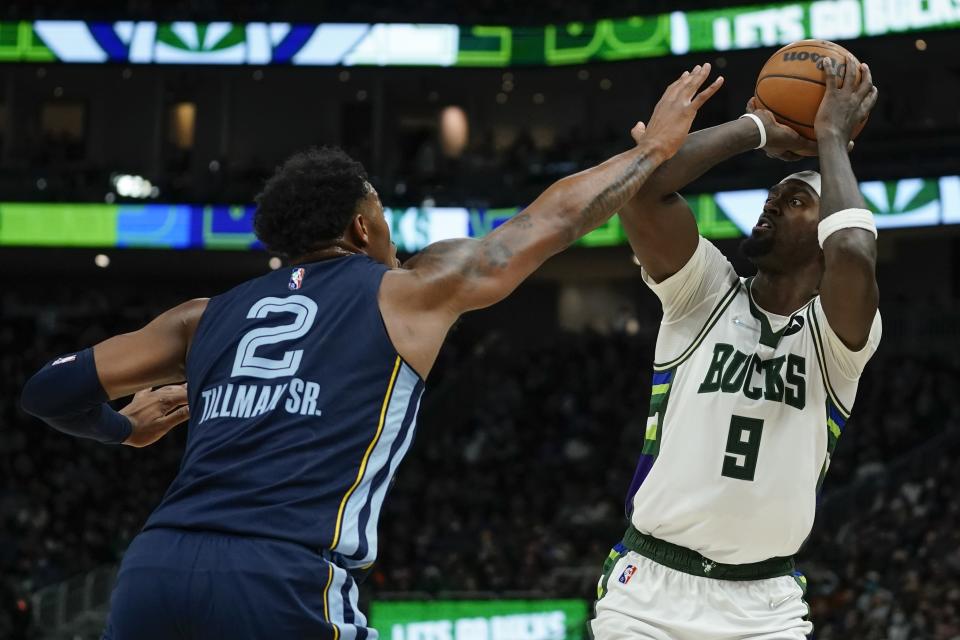 Milwaukee Bucks' Bobby Portis shoots with Memphis Grizzlies' Xavier Tillman defending during the first half of an NBA basketball game Wednesday, Jan. 19, 2022, in Milwaukee. (AP Photo/Morry Gash)