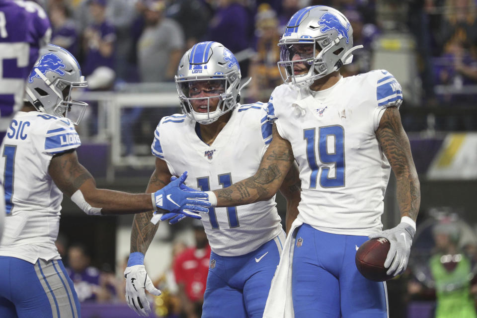Detroit Lions wide receiver Kenny Golladay (19) is congratulated by running back J.D. McKissic (41) and wide receiver Marvin Jones (11) during an NFL game against the Minnesota Vikings, Sunday, Dec. 8, 2019 in Minneapolis. The Vikings defeated the Lions 20-7. (Margaret Bowles via AP)