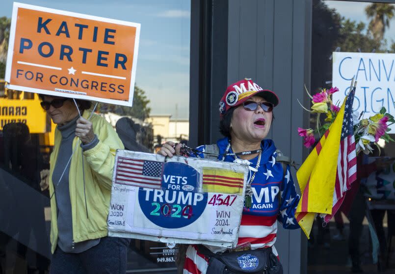 Victoria Cooper, right, yells as supporters depart a brief Katie Porter's rally on Nov. 5 in Huntington Beach, CA.