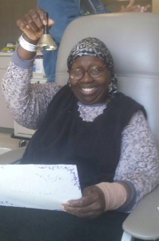 The author's mother ringing the bell after her last chemotherapy treatment.