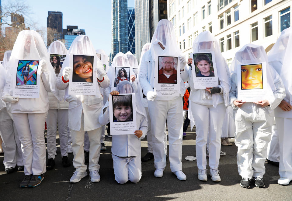 <p>Protesters hold photos of victims of school shootings during a New York City March For Our Lives demonstration demanding stricter gun control. (Photo: Shannon Stapleton/Reuters) </p>