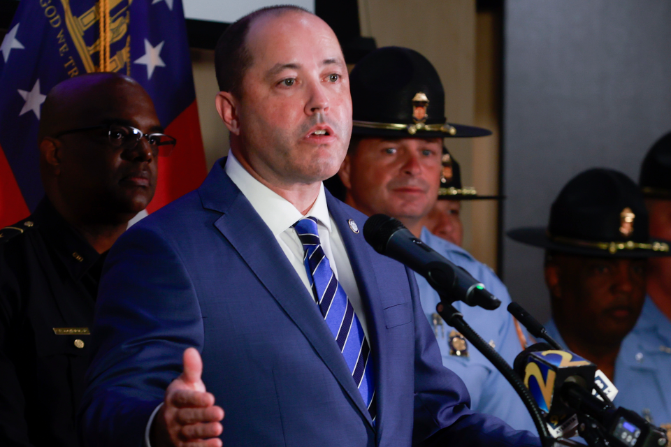 Georgia Attorney General Chris Carr speaks at a podium.