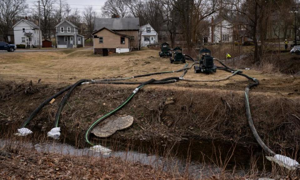 A crew works alongside a stream as cleanup efforts continue in East Palestine, Ohio.