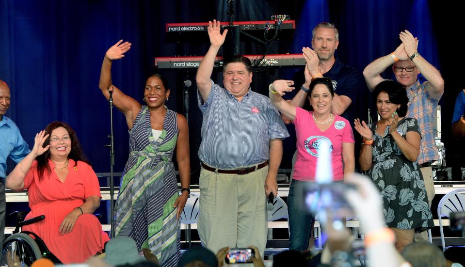 Gov. JB Pritzker, center, stands on stage with other Democratic candidates during Governors' Day at last years Illinois State Fair on Wednesday, Aug. 17, 2022.