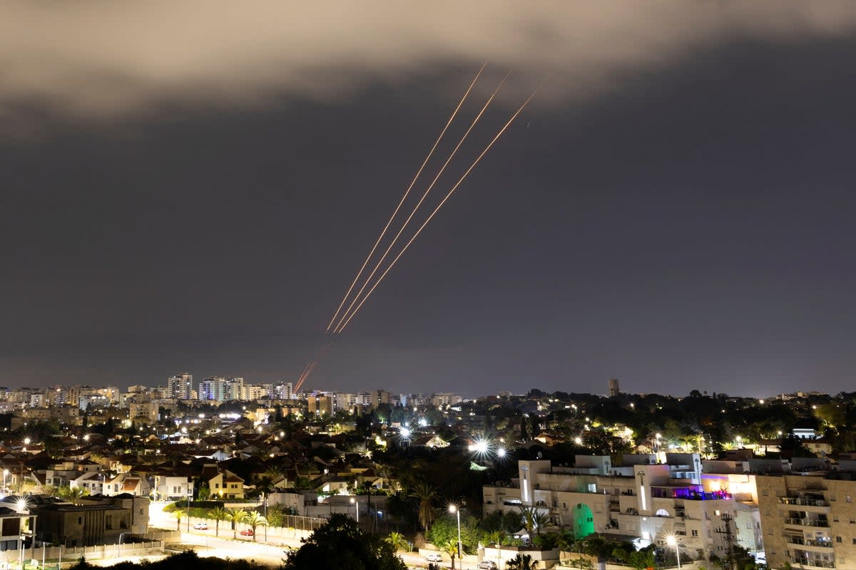 An anti-missile battery opens fire in Ashkelon during Iran’s attack (Reuters)