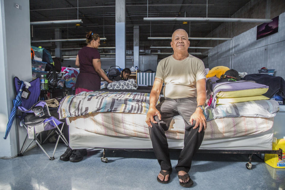 Jesse Biluk, a Micronesian migrant, poses for a portrait on his familyʻs bed at the Kaʻaʻahi Homeless Shelter for Women and Families in Honolulu, HI on Dec. 28, 2018. (Photo: Marie Eriel Hobro for HuffPost)