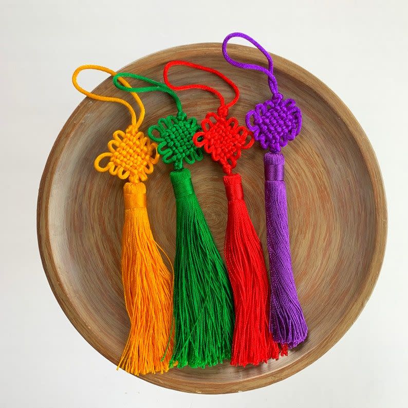 <p>Chinese Knot Fortune Tassel</p><p>etsy.com</p><p>$11.20</p><p><a href="https://go.redirectingat.com?id=74968X1596630&url=https%3A%2F%2Fwww.etsy.com%2Flisting%2F1158850657%2Flenora-dame-raw-materials-4-pcs-chinese&sref=https%3A%2F%2Fwww.cosmopolitan.com%2Flifestyle%2Fa35383950%2Fchinese-new-year-decorations%2F" rel="nofollow noopener" target="_blank" data-ylk="slk:Shop Now;elm:context_link;itc:0;sec:content-canvas" class="link rapid-noclick-resp">Shop Now</a></p><span class="copyright">Etsy</span>