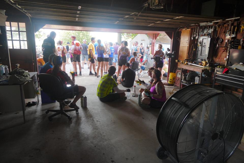 Riders cool off in the shade at the Iowa Craft Beer stop as RAGBRAI 50 rolls towards Coralville Friday, July 28, 2023.