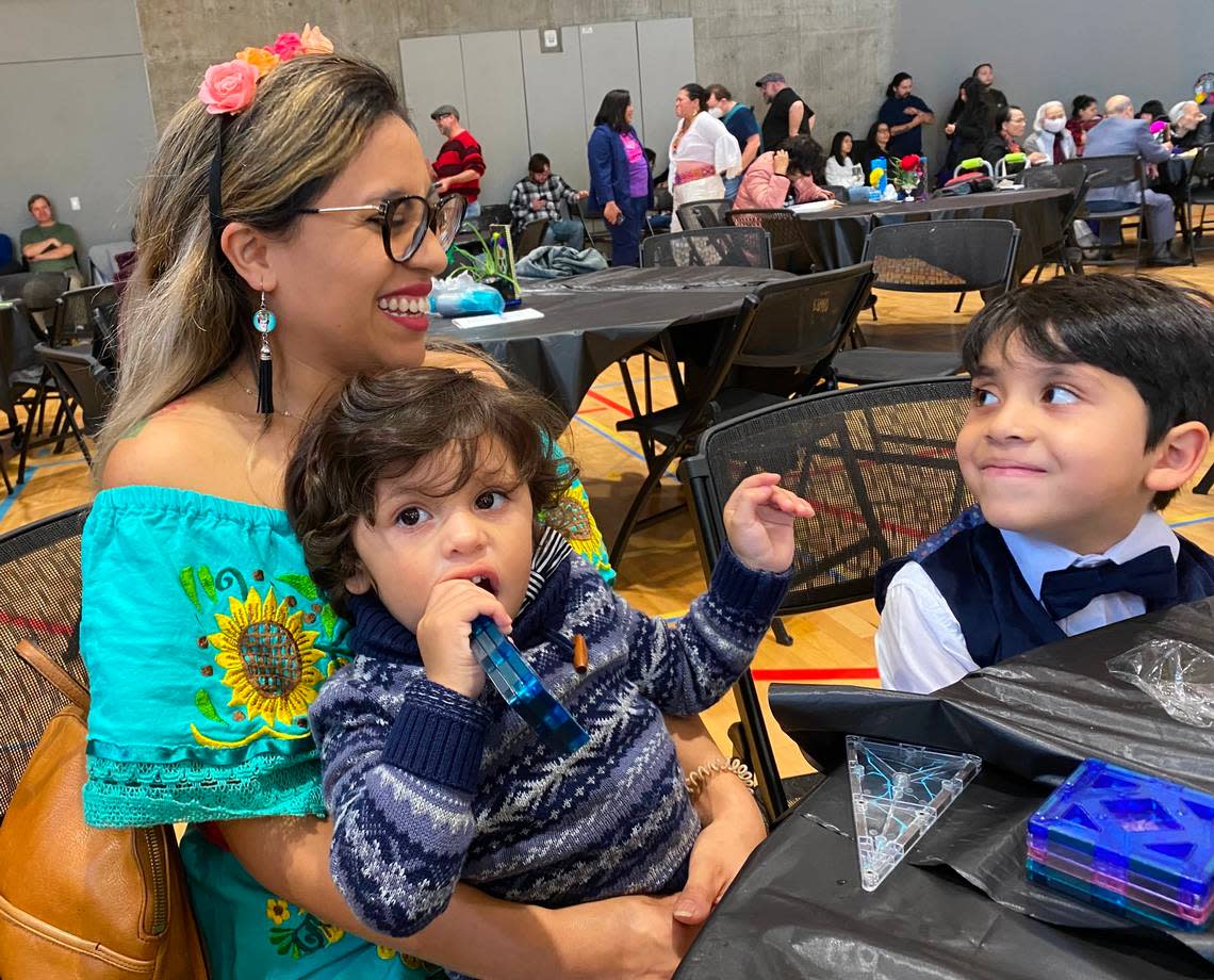 Ana Castellani and sons Theodore, 2, and Vinny, 5, of Port Orchard attend Saturday’s Dia de los Muertos celebration at the Eastside Community Center in Tacoma.