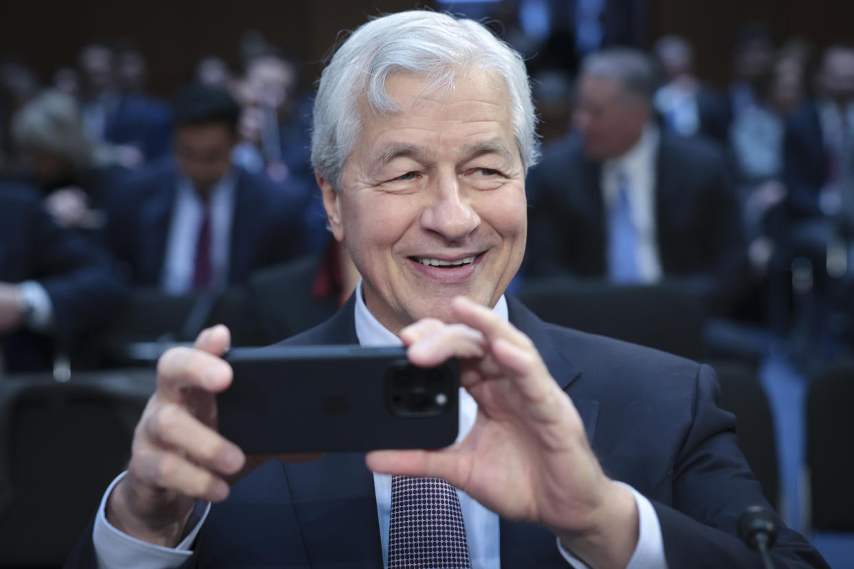 WASHINGTON, DC - DECEMBER 06: Jamie Dimon, Chairman and CEO of JPMorgan Chase, takes a picture of news photographers as he arrives to testify at a Senate Banking Committee hearing at the Hart Senate Office Building on December 06, 2023 in Washington, DC. The committee heard testimony from the largest financial institutions during an oversight hearing on Wall Street firms.  (Photo by Win McNamee/Getty Images)