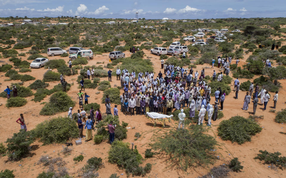 In this photo taken Thursday, April 30, 2020, mourners gather for the burial of an elderly man believed to have died from the coronavirus in Mogadishu, Somalia. Years of conflict, instability and poverty have left Somalia ill-equipped to handle a health crisis like the coronavirus pandemic. (AP Photo)