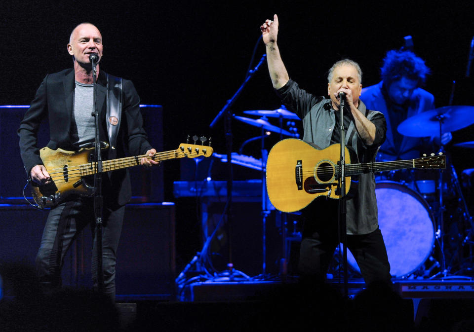 Musicians Sting, left, and Paul Simon perform together in concert at Madison Square Garden on Tuesday, March 4, 2014, in New York. (Photo by Evan Agostini/Invision/AP)