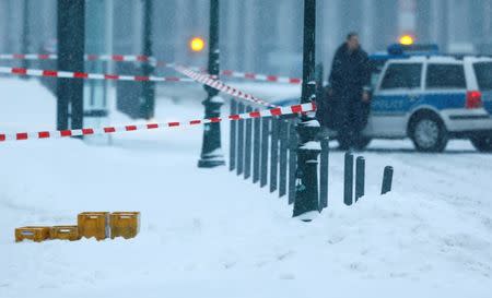 A police car is parked behind suspicious yellow postal crates near the chancellery in Berlin, Germany on January 6, 2016. REUTERS/Hannibal Hanschke