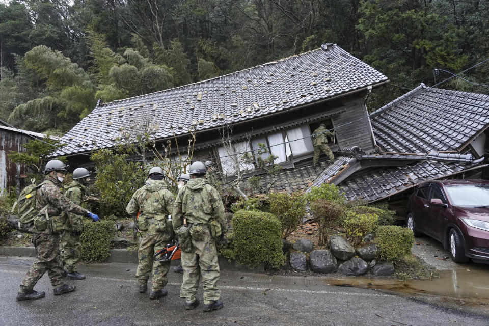 Japanese Self Defense Force members inspect a collapsed house hit by earthquakes in Suzu, Ishikawa prefecture, Japan Wednesday, Jan. 3, 2024. (Kyodo News via AP)