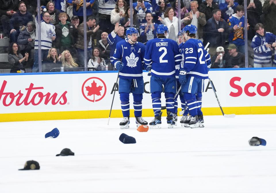 Hats litter the ice after Toronto Maple Leafs center Auston Matthews (34) scores his third goal against the Anaheim Ducks.