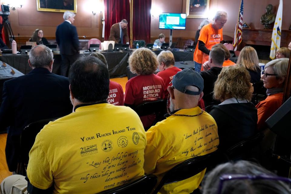 Both sides of the of gun legislation debate settle in the House lounge at the State House on March 13.