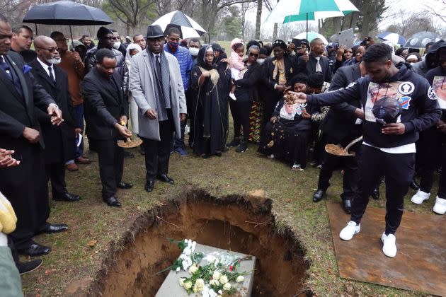 Mourners toss dirt into the grave of Patrick Lyoya as he is laid to rest at Resurrection Cemetery on April 22, 2022, in Wyoming, Michigan. (Photo: Scott Olson via Getty Images)