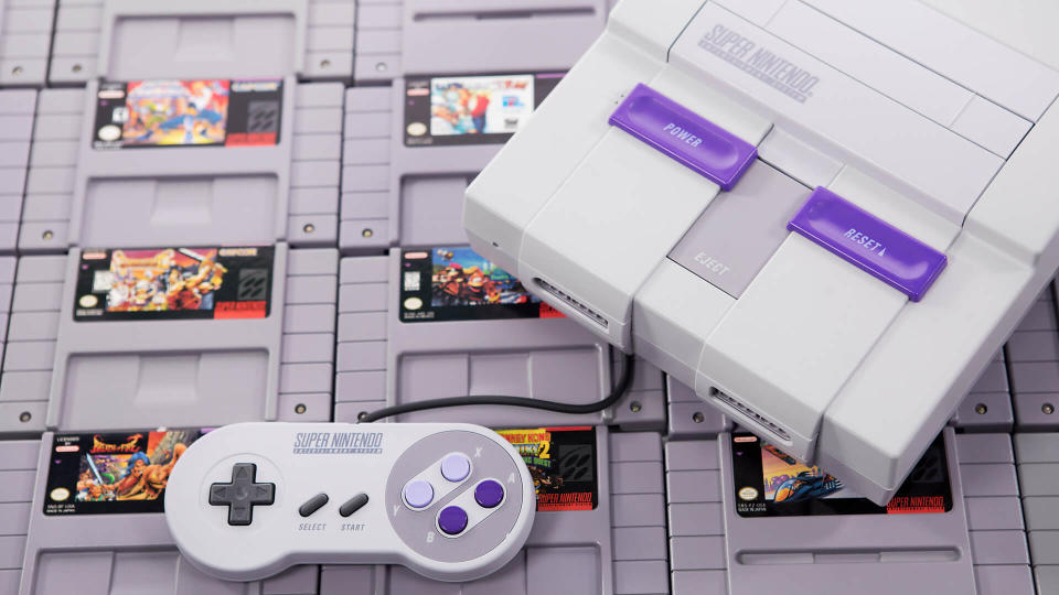 Taipei, Taiwan - June 19, 2019: A Nintendo SNES system and controller on top of cartridges - Image.