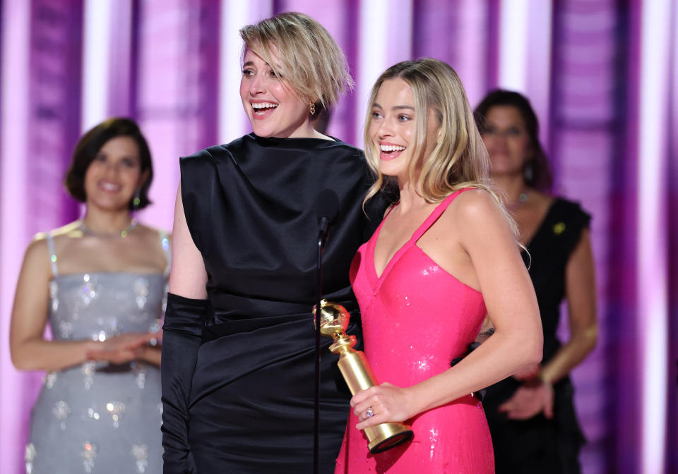 Greta Gerwig and Margot Robbie accept the award for Cinematic and Box Office Achievement for 