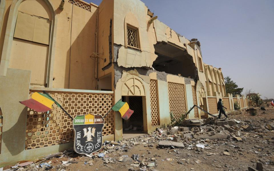 A man walks out of a building of the rebels of the Movement for Oneness and Jihad in West Africa which has been destroyed by French air strikes - SIA KAMBOU /AFP