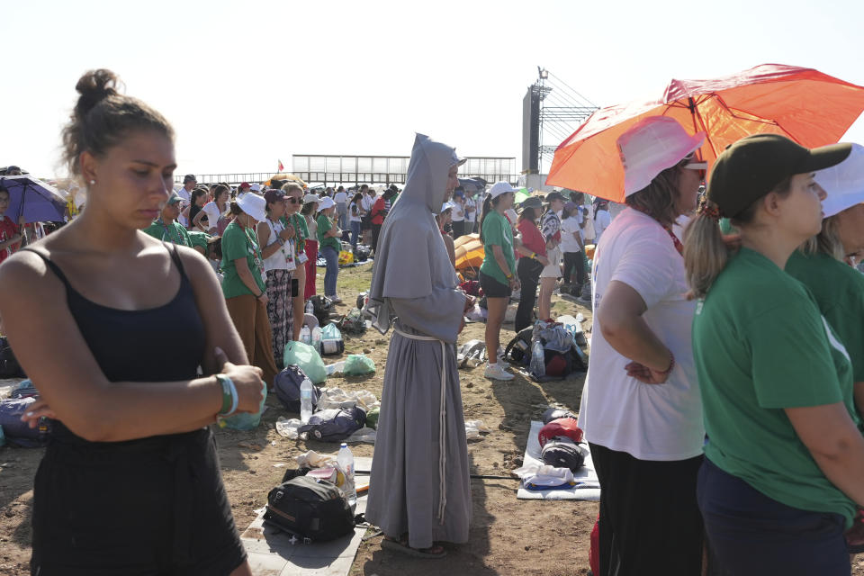 Pilgrims gather at Parque Tejo in Lisbon where Pope Francis is presiding over a mass celebrating the 37th World Youth Day, Sunday, Aug. 6, 2023. An estimated 1.5 million young people filled the parque on Saturday for Pope Francis' World Youth Day vigil, braving scorching heat to secure a spot for the evening prayer and to camp out overnight for his final farewell Mass on Sunday morning. (AP Photo/Ana Brigida)