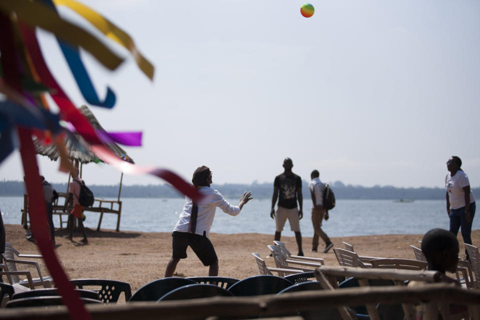 Ugandans play handball during the 3rd Annual Lesbian, Gay, Bisexual and Transgender (LGBT) Pride celebrations in Entebbe, Uganda, Saturday, Aug. 9, 2014.  Scores of Ugandan homosexuals and their supporters are holding a gay pride parade on a beach in the lakeside town of Entebbe. The parade is their first public event since a Ugandan court invalidated an anti-gay law that was widely condemned by some Western governments and rights watchdogs. (AP Photo/Rebecca Vassie)