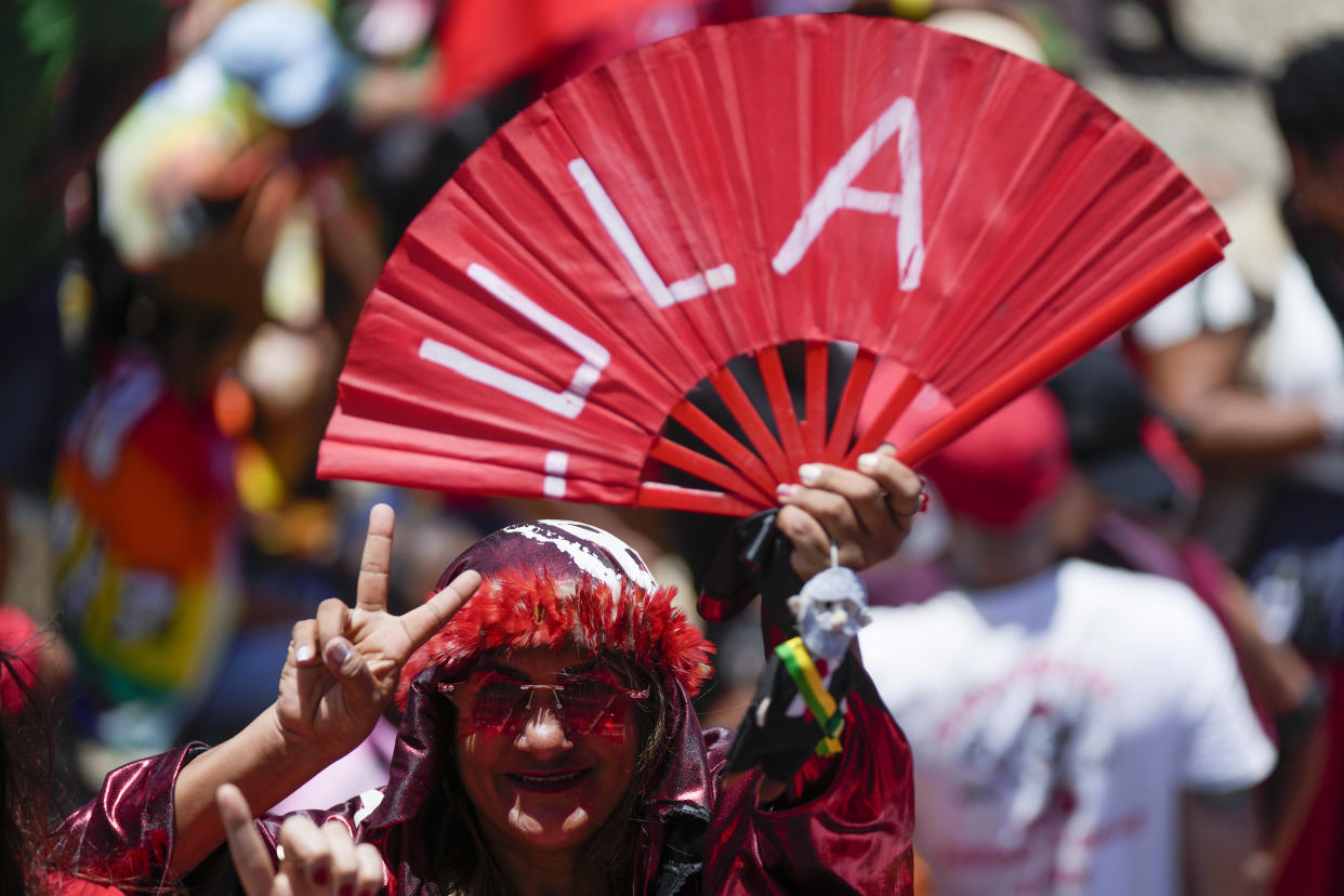 A supporters of Luiz Inacio Lula da Silva flashes a victory sign prior to his inauguration as new president in Brasilia, Brazil, Sunday, Jan. 1, 2023. (AP Photo/Silvia Izquierdo)