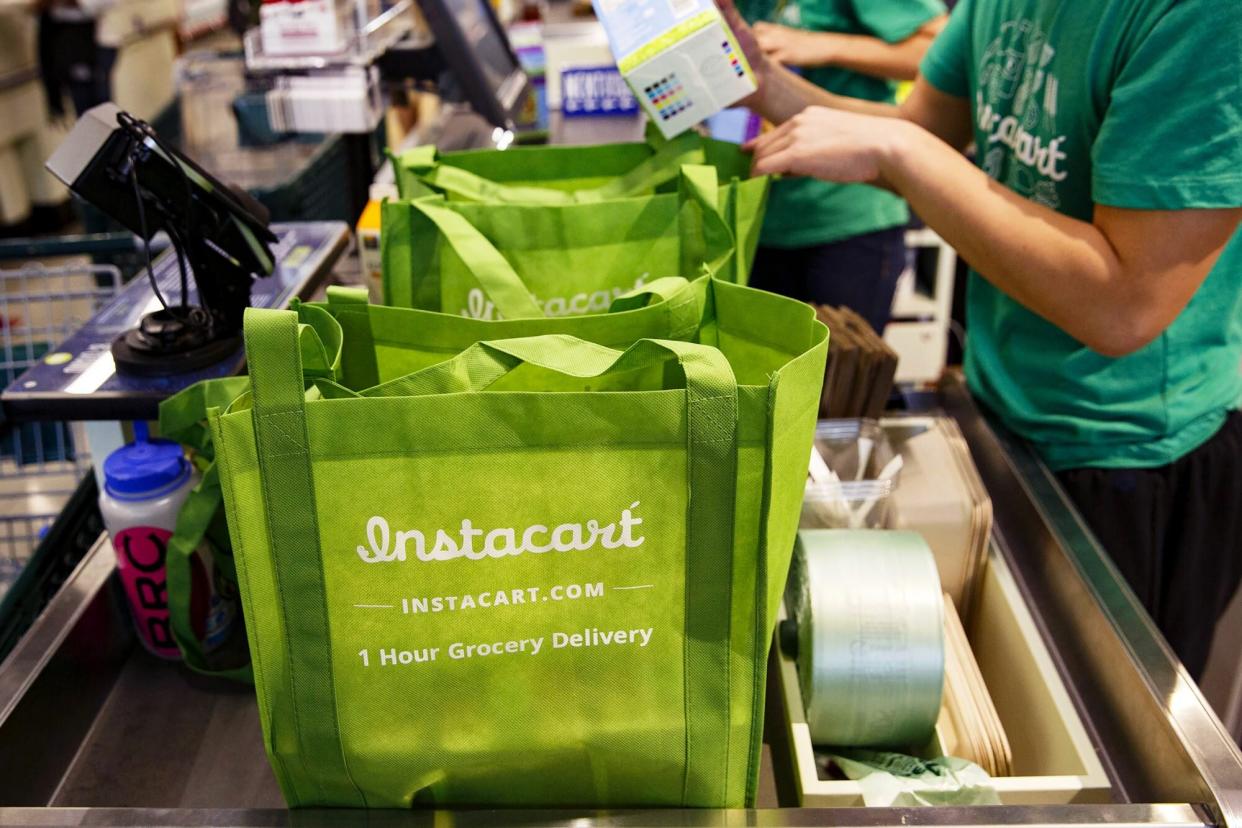 InstaCart employees fulfill orders for delivery