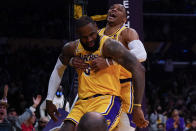 Los Angeles Lakers forward LeBron James (6) is helped off the floor by guard Russell Westbrook, right, during the first half of an NBA basketball game against the Indiana Pacers in Los Angeles, Wednesday, Jan. 19, 2022. (AP Photo/Ashley Landis)