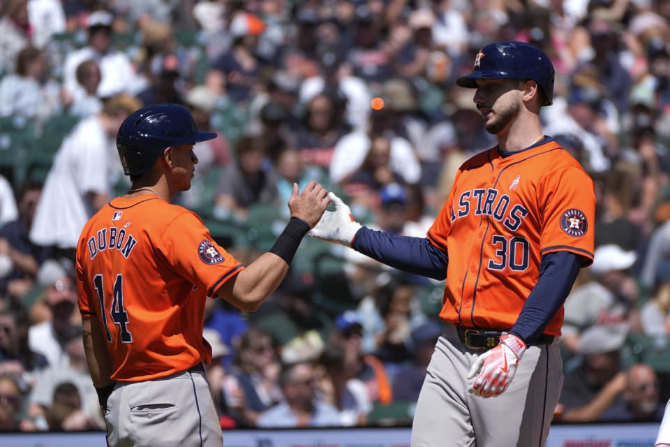 Houston Astros' Kyle Tucker (30) celebrates his two-run home run with Mauricio Dubón (14) against the Detroit Tigers in the sixth inning of a baseball game, Sunday, May 12, 2024, in Detroit. (AP Photo/Paul Sancya)