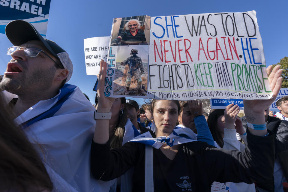 Talia Raab, holds up a picture of her grandmother, living holocaust survivor Edith Raab 98, during a March for Israel rally on the National Mall in Washington, Tuesday, Nov. 14, 2023. (AP Photo/Manuel Balce Ceneta)