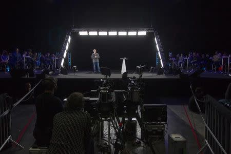 Technicians are seen with equipment used to produce a hologram that is trasmitted to a gathering in Saint-Denis as politician Jean-Luc Melenchon, of the French far-left Parti de Gauche, and candidate for the 2017 French presidential election, speaks on stage during a campaign rally in Chassieu, near Lyon, France, February 5, 2017. REUTERS/Emmanuel Foudrot