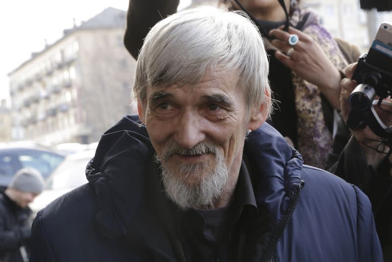 FILE PHOTO: Historian Yuri Dmitriev speaks with people outside a court building in Petrozavodsk