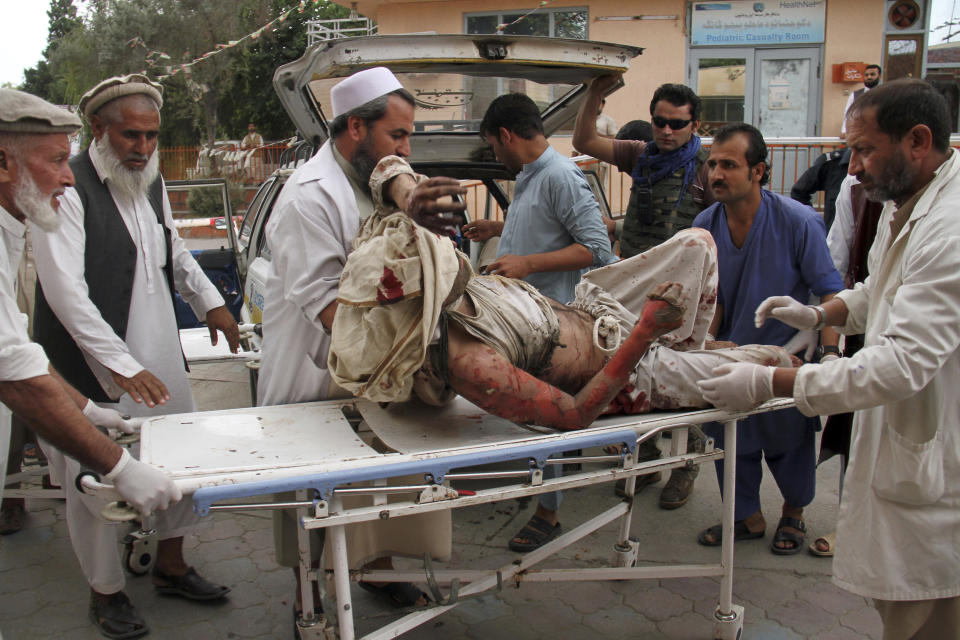 FILE - A wounded man is brought by stretcher into a hospital after a mortar was fired by insurgents in Haskamena district of Jalalabad east of Kabul, Afghanistan, Oct. 18, 2019. (AP Photo/Wali Sabawoon, File)