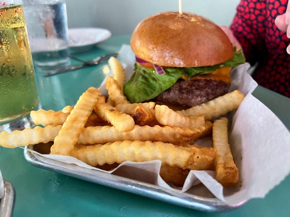 The surf and turf burger touts cheese, shrimp, lettuce, tomato and onion atop a plump patty.