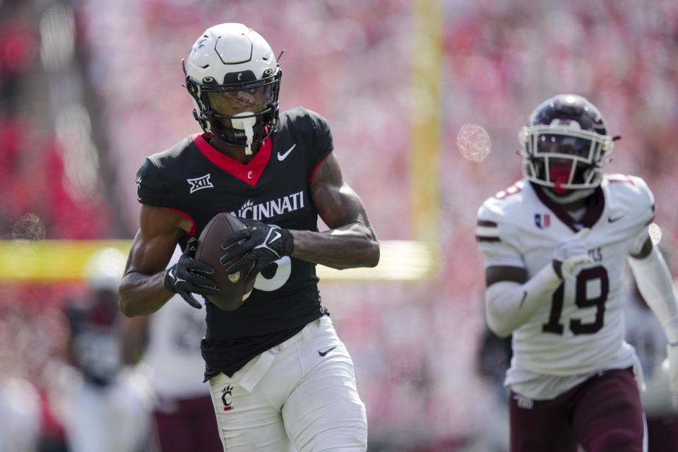 Cincinnati wide receiver Xzavier Henderson catches a pass for a touchdown during the first half of an NCAA college football game against Eastern Kentucky, Saturday, Sept. 2, 2023, in Cincinnati. (AP Photo/Aaron Doster)