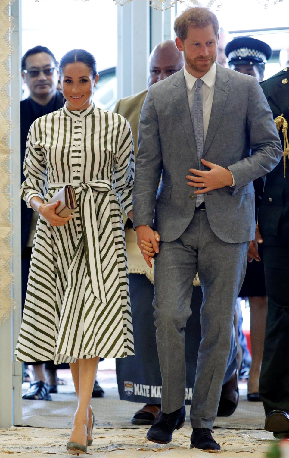 <p>On October 26, the Duke and Duchess of Sussex met with Tonga Prime Minister Akilisi Pohiva. For the occasion, Meghan dressed in a striped midi dress by Martin Grant – a label she has looked to throughout the tour. She accessorised the daytime look with a Prada clutch, stud earrings from Birks and olive green shoes. <em>[Photo: Getty]</em> </p>