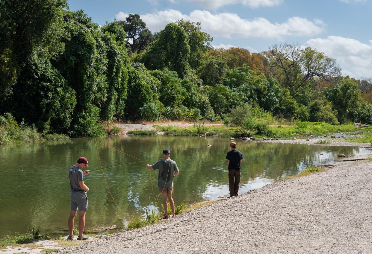 Southwestern University students Scott Johnson, left, Lukas Silvius and Dominick Arnold fish from the banks of the San Gabriel River at Blue Hole Park, Wednesday, Aug. 23, 2023 in Georgetown.