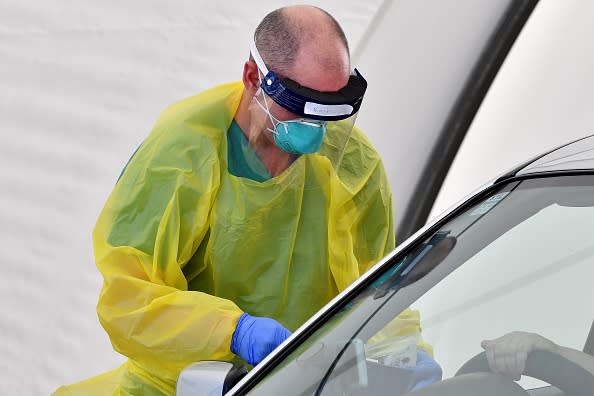 A medic performs COVID-19 tests on a member of the public at a drive-through COVID-19 testing center on Bondi Beach in Sydney.