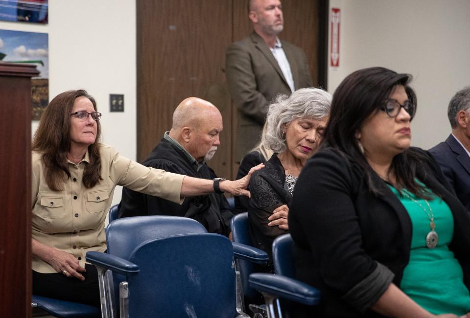 Presiding Judge of the 5th Administrative Judicial Region Missy Medary comforts Rosaena Mushel, the mother of a man who suffered from severe mental illness that drove him to kill his father and burn down their family home, at the Nueces County Commissioners Court meeting in Corpus Christi, Texas, on April 19, 2022.