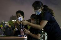 People offer prayers for the victims of the U.S. 1945 atomic bombing, at the Peace Memorial Park in Hiroshima, Japan