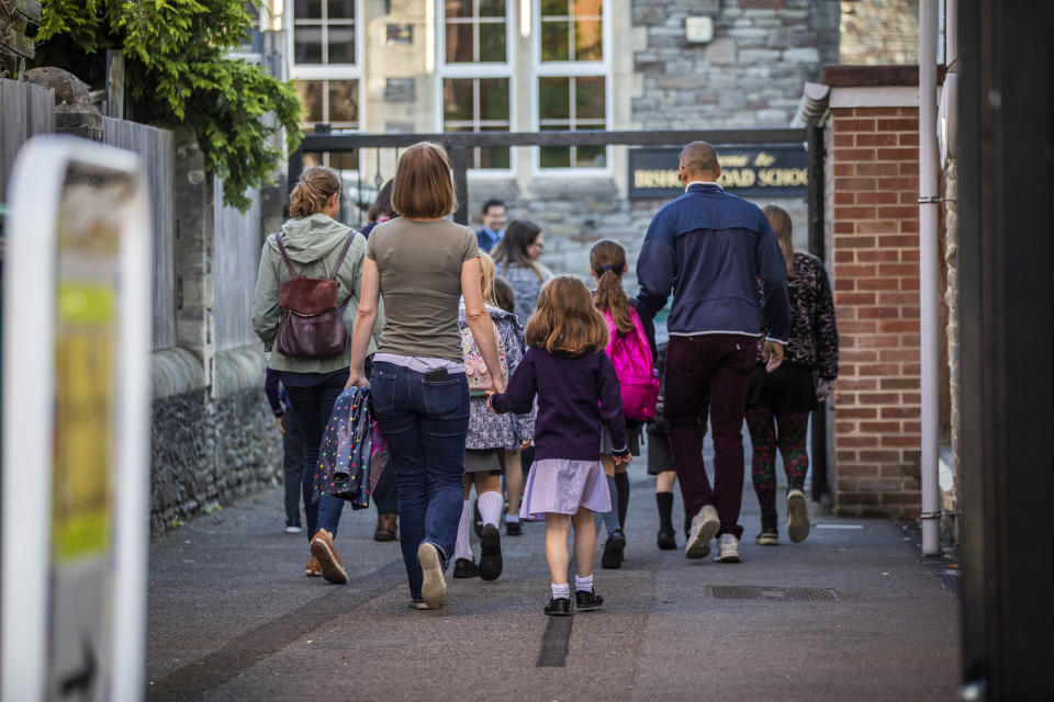 Parents walk their children into Bishop's Road Primary School as schools reopen. Bristol. 1 September 2020.   See SWNS story SWBRschool. Many schools are returning in full for the first time since March.