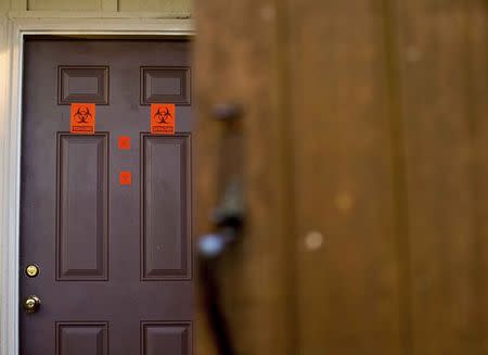A view of the front door, which now has biohazard stickers, of the apartment where three young Muslims were killed on Tuesday, in Chapel Hill, North Carolina, February 11, 2015. REUTERS/Chris Keane