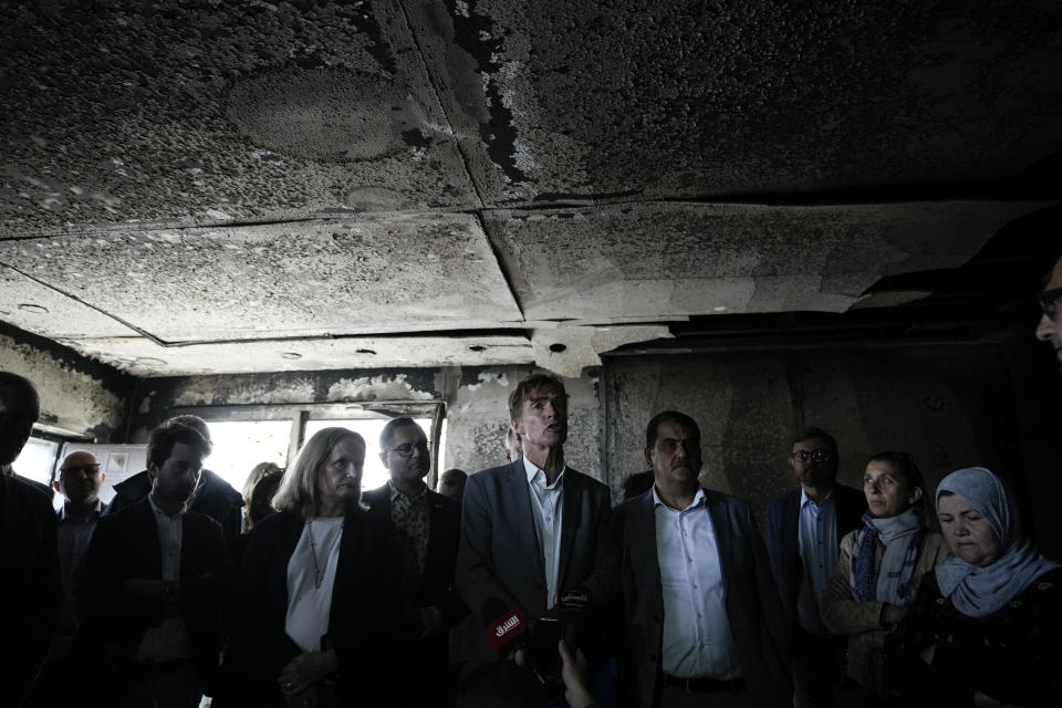 Sven Kuhn von Burgsdorff, the European Union representative for the Palestinian Territories, center, surveys the damage of a torched house in the West Bank town of Hawara which was set ablaze by radical Jewish settlers earlier this week, Friday, March 3, 2023. On Monday scores of Israeli settlers have gone on a violent rampage in the northern West Bank town of Hawara, setting cars and homes on fire after two settlers were killed by a Palestinian gunman. (AP Photo/Majdi Mohammed)