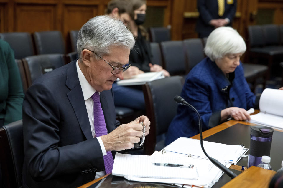 Federal Reserve Chairman Jerome Powell adjusts his watch as he prepares to speak to lawmakers during a House Committee on Financial Services hearing on Capitol Hill in Washington, Wednesday, Dec. 1, 2021. Treasury Secretary Janet Yellen is seated right. (AP Photo/Amanda Andrade-Rhoades)