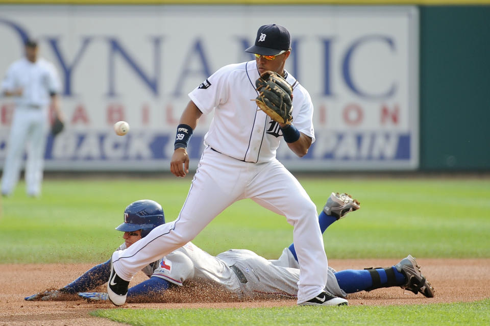 DETROIT, MI - OCTOBER 13: Ian Kinsler #5 of the Texas Rangers slides in safe at second base past Ramon Santiago #39 of the Detroit Tigers after hitting a double in the first inning of Game Five of the American League Championship Series at Comerica Park on October 13, 2011 in Detroit, Michigan. (Photo by Harry How/Getty Images)